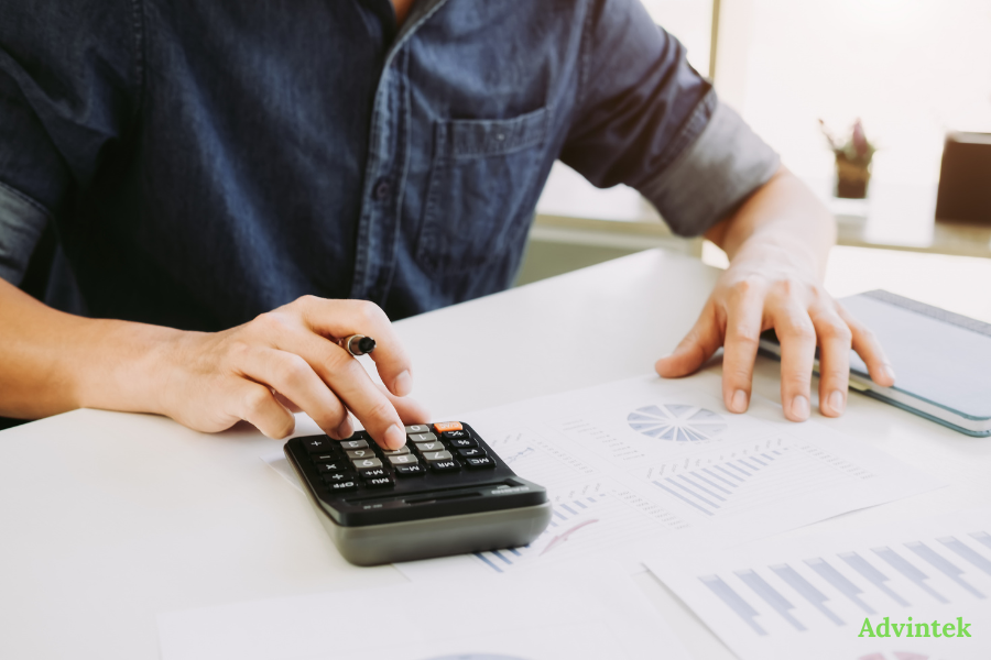 PINT AE Format Explained: The UAE’s Mandatory XML Invoice Standard 3 Finance professional reviewing reports with fta compliant invoicing software for PINT AE UAE e-invoicing compliance