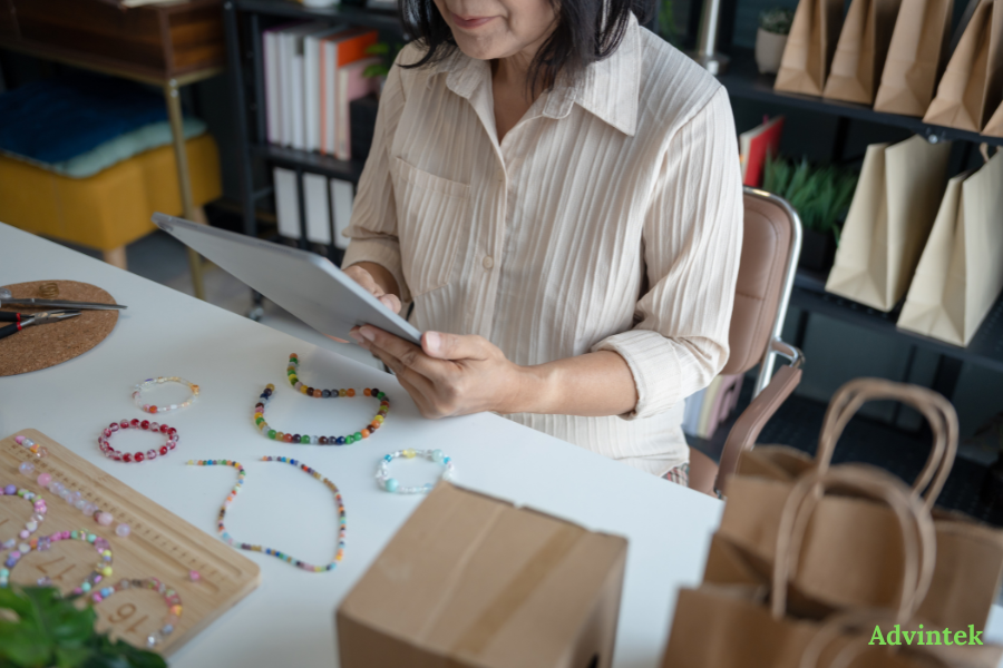 UAE E-Invoicing Penalties 2026: What AED 5,000/Month Really Means for Your Business 2 Small business owner using a tablet to manage invoices, orders, and e-invoicing readiness.