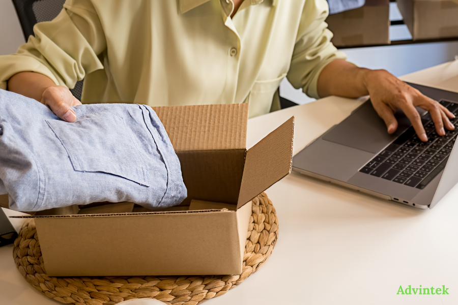 SME packing online orders while managing UAE e-invoicing records on laptop