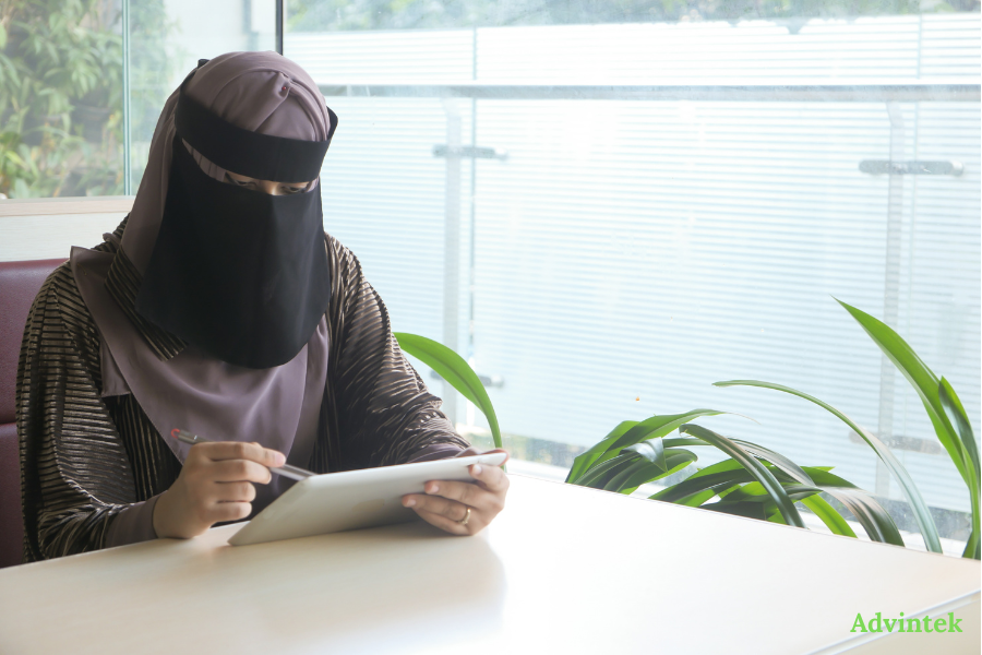 What Is Peppol and Why Has the UAE Chosen It for E-Invoicing? 2 Woman reviewing digital documents on tablet for UAE e-invoicing compliance