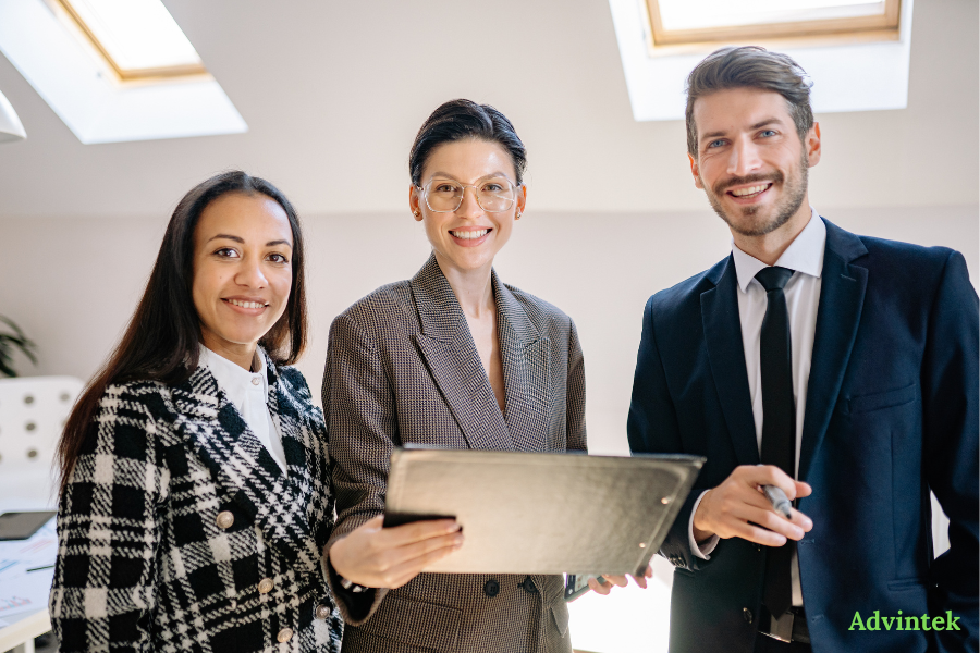 Peppol E-Invoicing and ERP Integration: How Your System Connects to the UAE Network 3 Business professionals reviewing digital invoice data on a tablet for e-invoicing compliance support